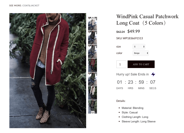 A long coat from a catalogue ad showing from the neck down woman standing outside near a bush.